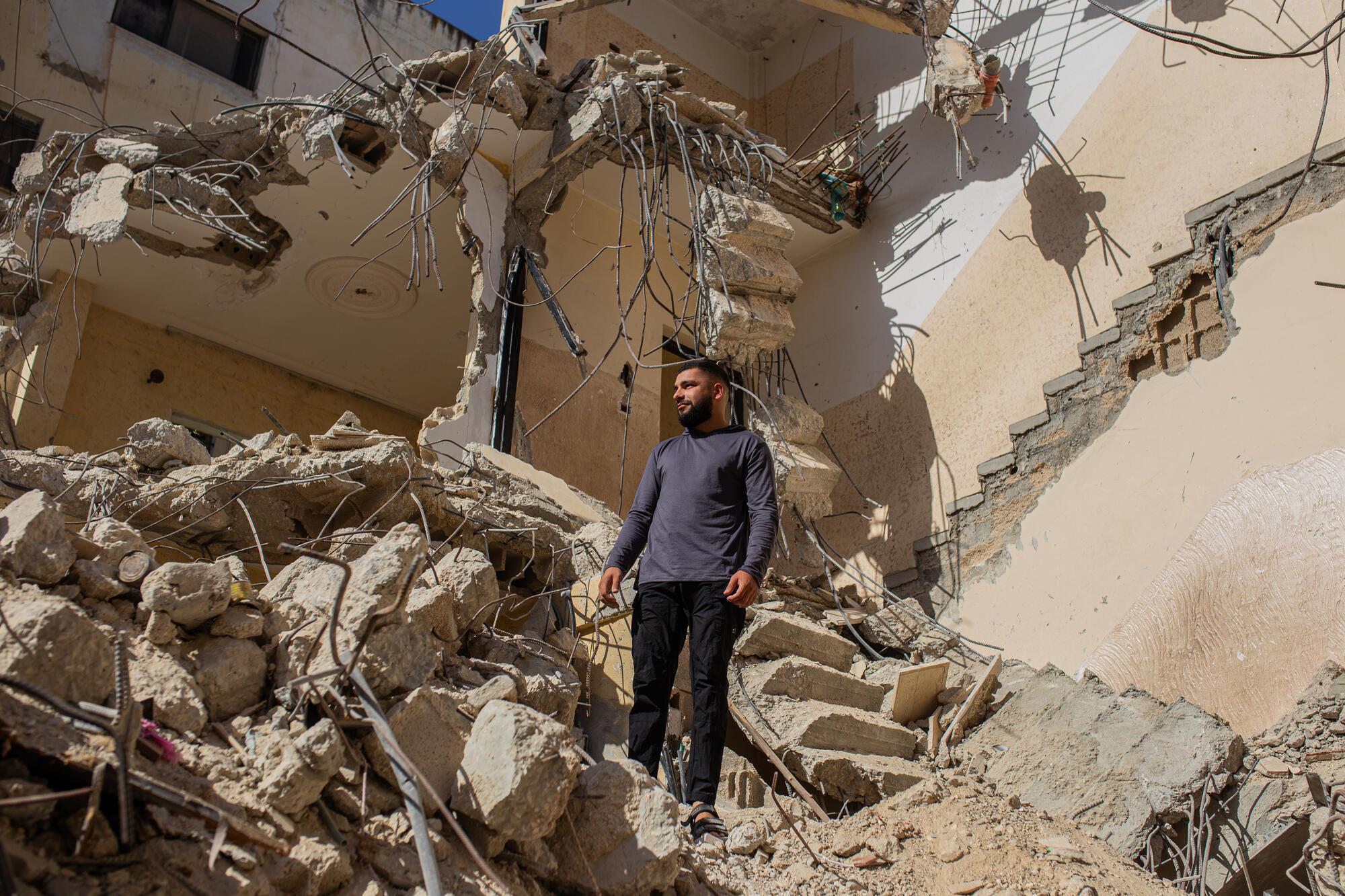 Omar stands in the rubble of his home after it was bulldozed by Israeli forces in Jenin refugee camp.