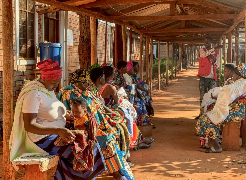 Health promoter, Bayubahe Jerome, educates mothers on the benefits of breastfeeding at Nduta Camp Clinic.