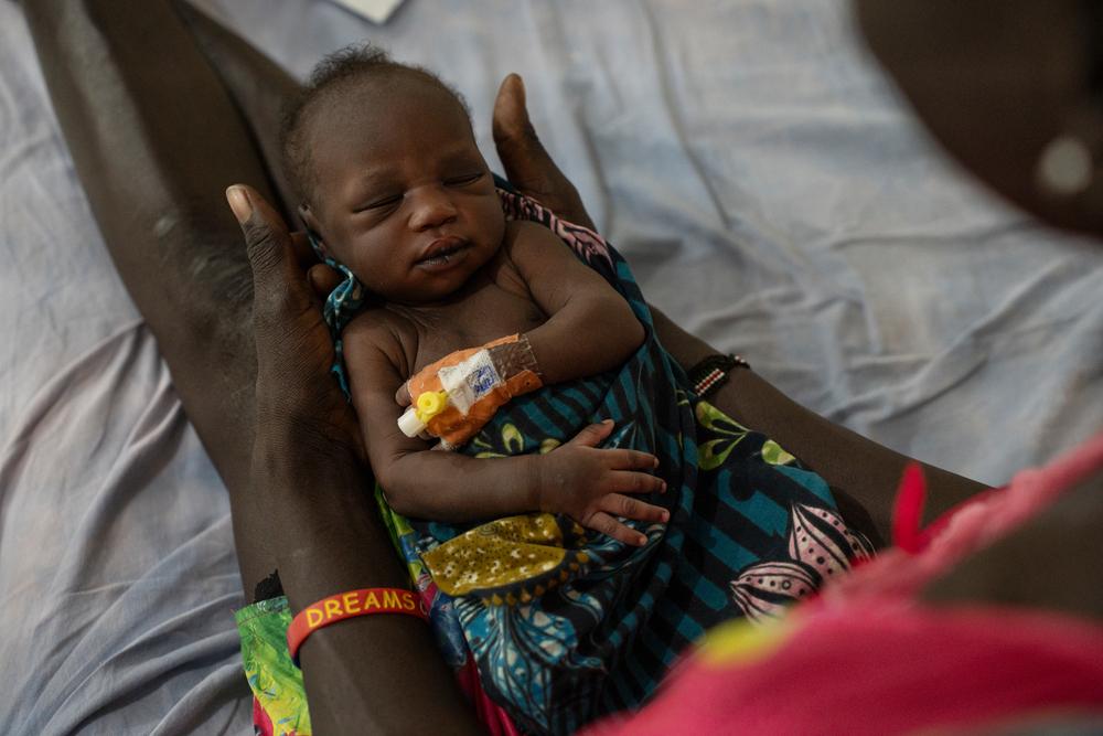 A mother holding a child