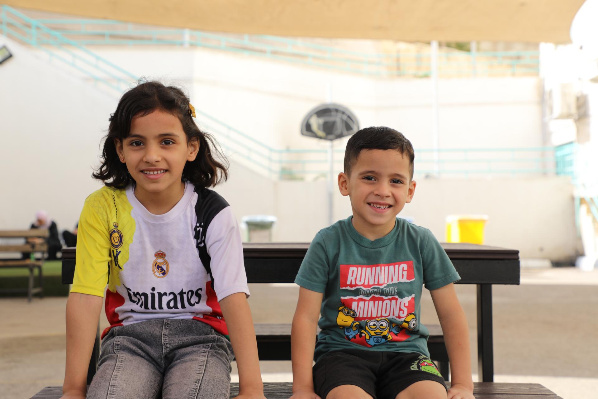 Omar sits with his sister in the playground at the reconstructive surgery hospital in Amman, Jordan. Omar was injured in an Israeli strike, after a piece of shrapnel tore through his leg.