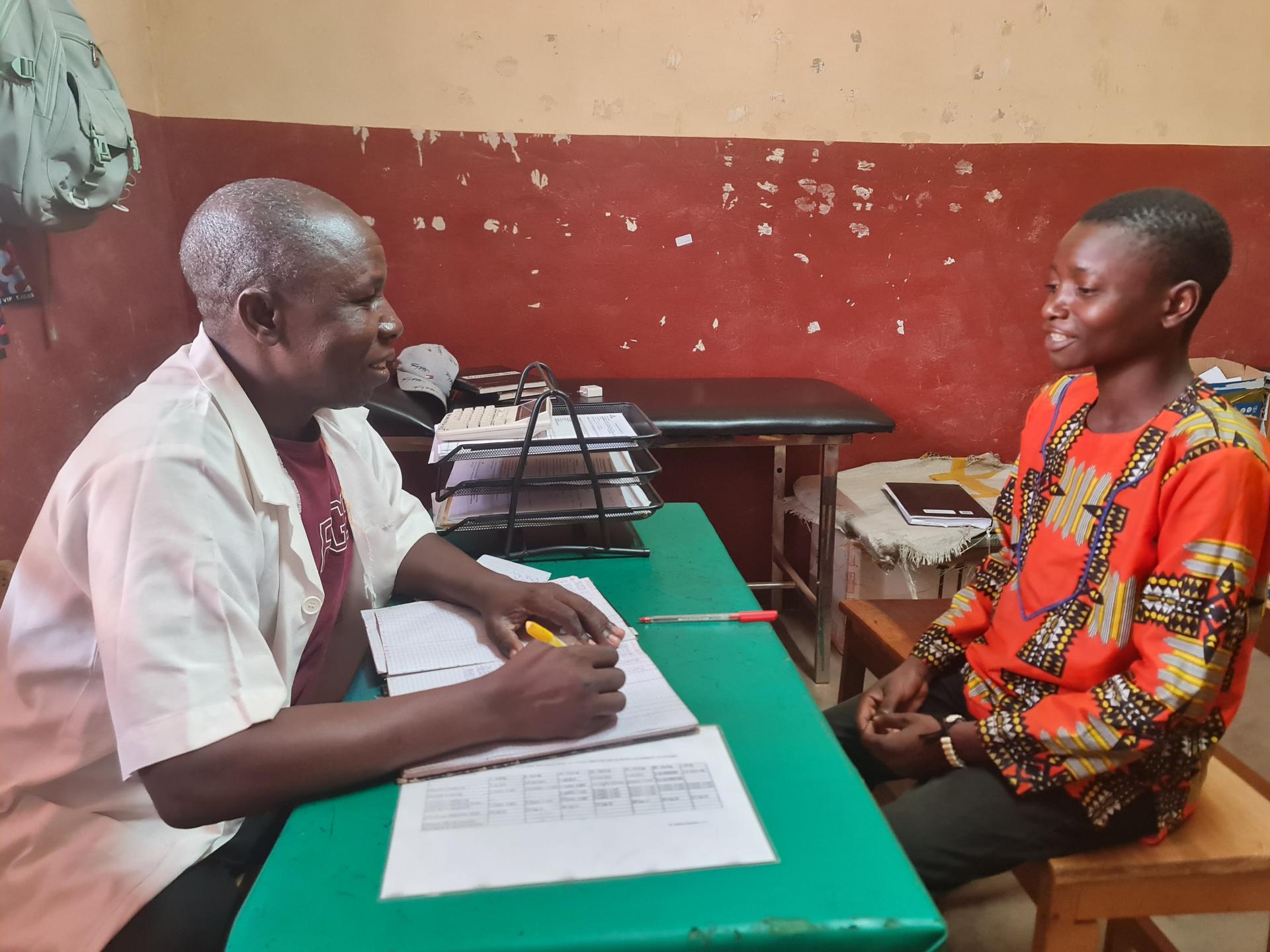 Adolphe Andao, 22, a type 1 diabetes patient, during a consultation with an MSF health worker at the chronic disease follow-up clinic in Carnot Hospital.