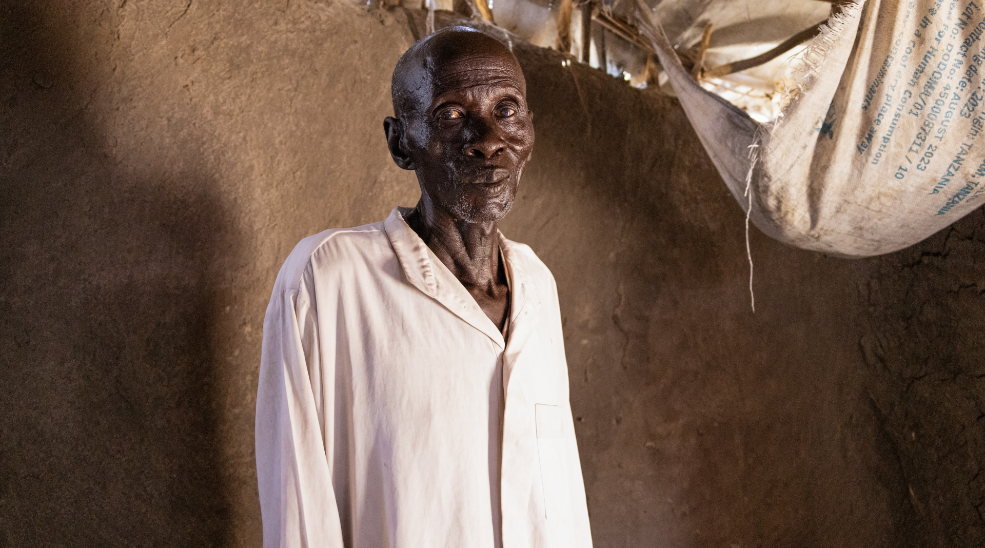 James Kuong Madeng, 60 years old, suffering from TB/HIV is standing inside his house in Leer.