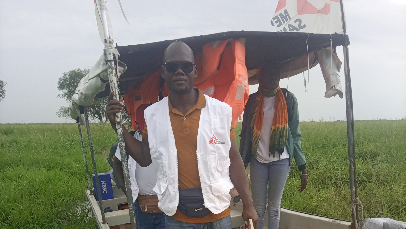 Getting out of the boat to walk to the community because the boat can not reach the docking point due to thick vegetation. 