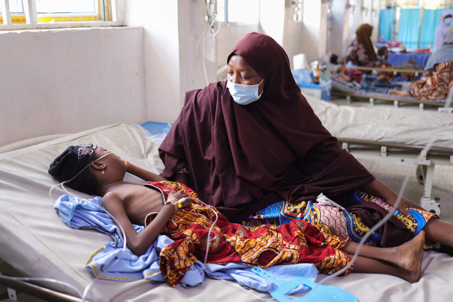 Halisa Mahmud looks caringly at her 11-year-old daughter Halima Arma, who is on admission for diphtheria, at the Intensive Care Unit of the Infectious Diseases Hospital, Kano state, northwest Nigeria.