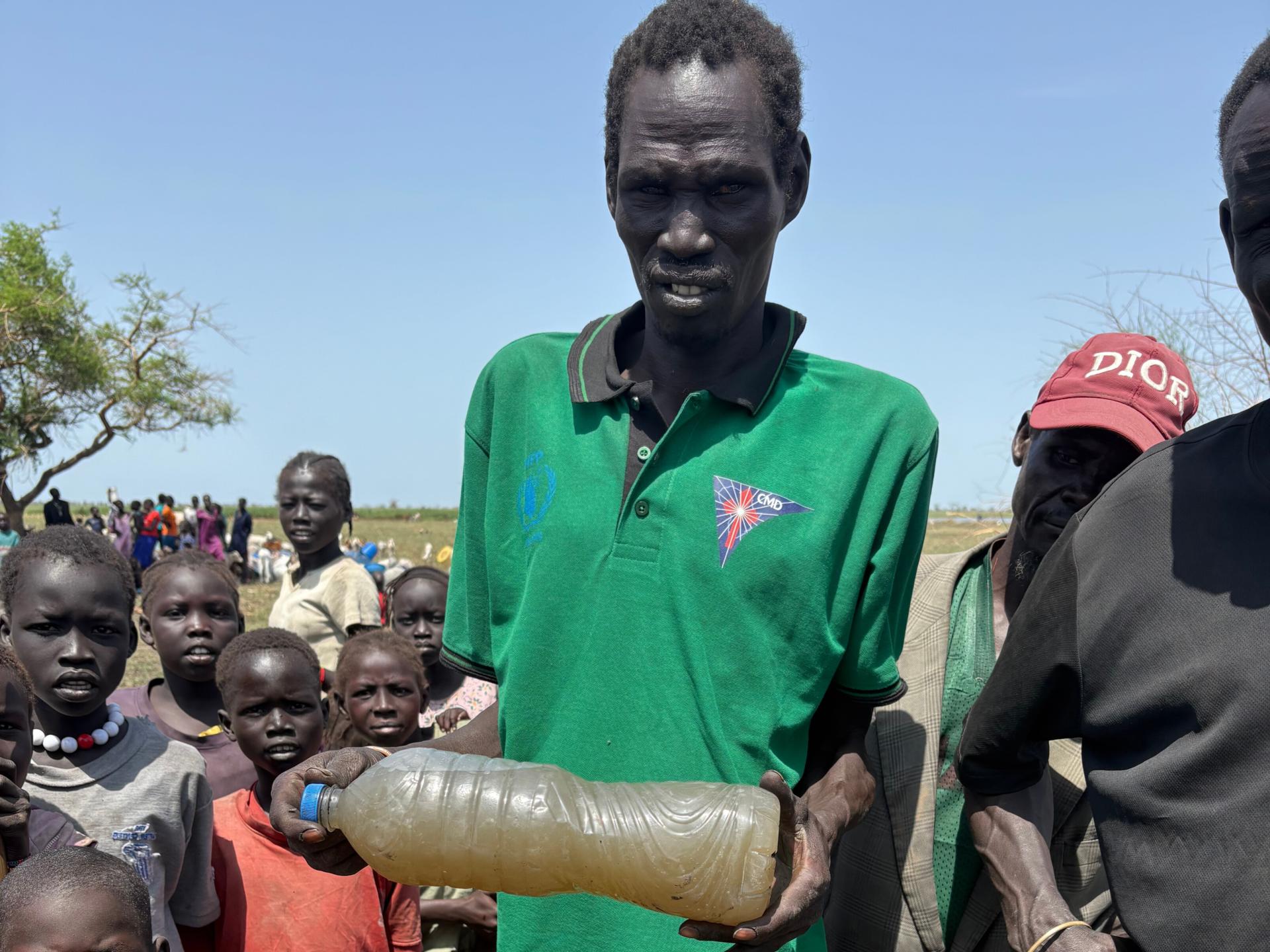 South Sudanese refugees in Ethiopia’s Gambella region collecting water from a contaminated source, highlighting the lack of sanitation and clean water access in the area.