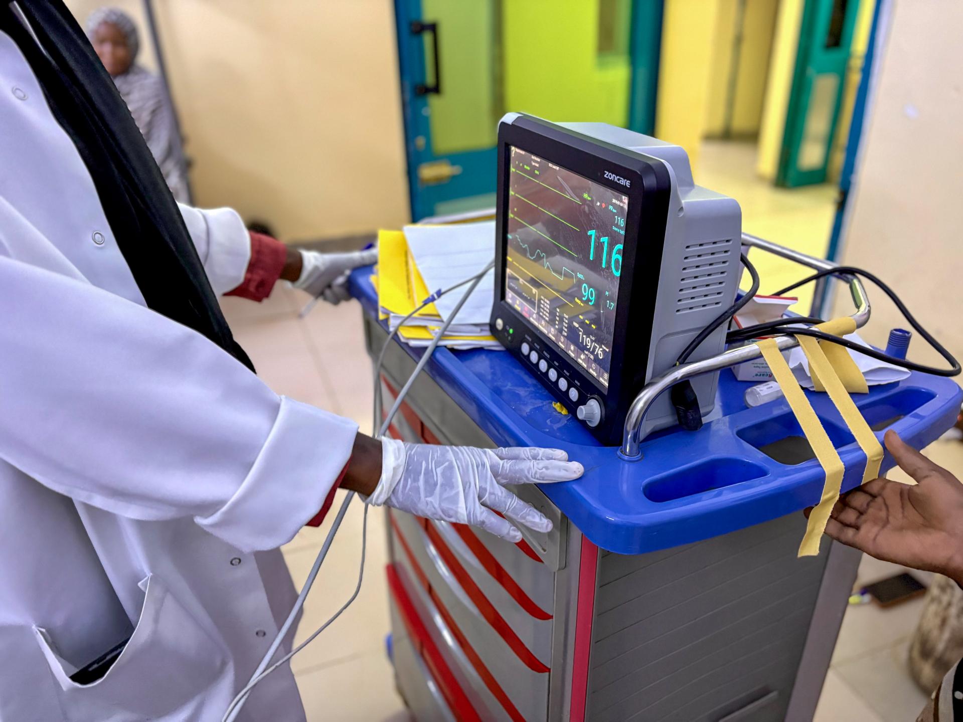 A medical staff is watching the monitor screen while checking a patient’s vital signs in the maternity ward of the hospital.