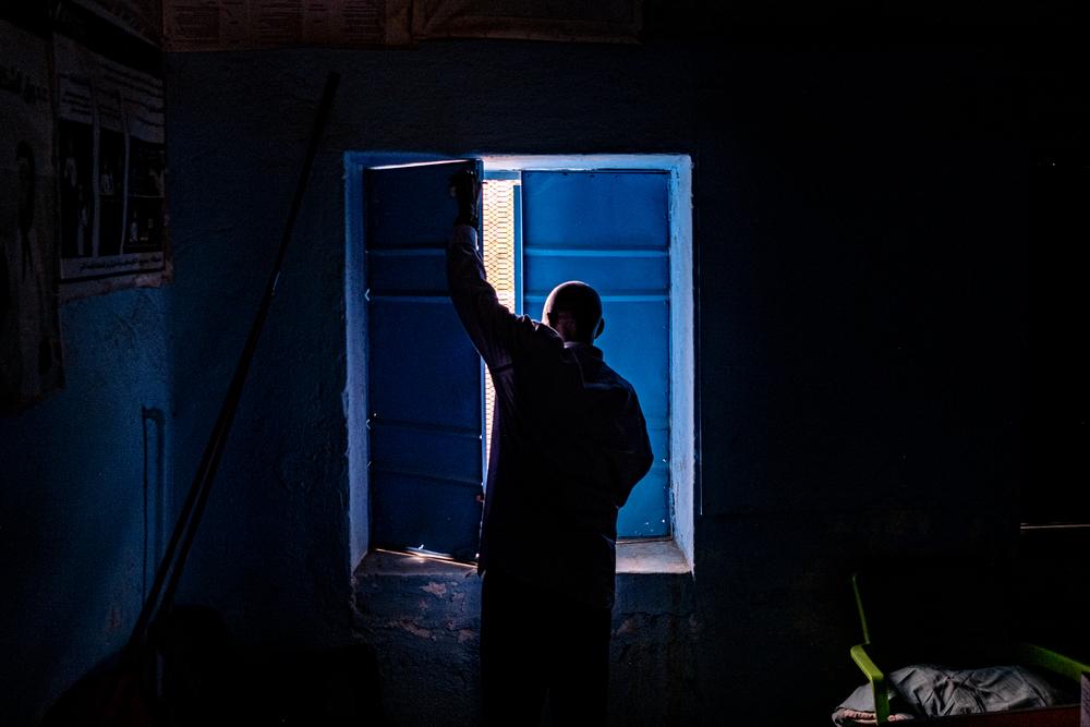 Medical assistant Jaffer Sadiq Abaker Saleh, closes the shutters at a primary health care centre which is no longer fully functional due to funding cuts. Hamidya IDP camp, Zalingei.