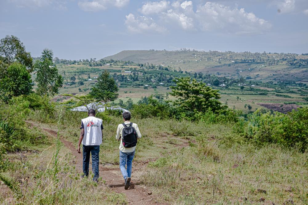 MSF staff walking in the field heading for a call-back during the NHIPS survey.