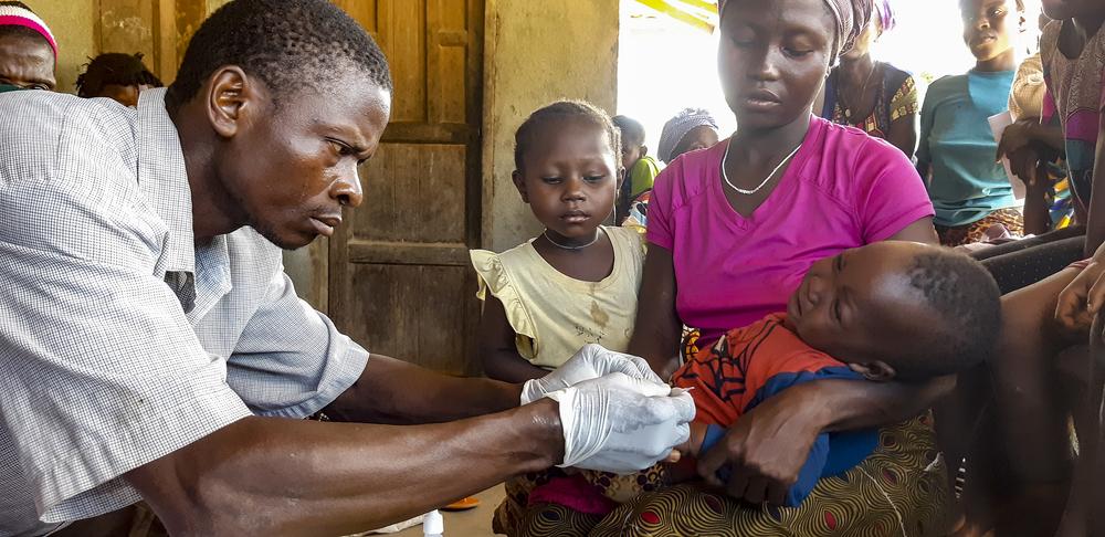 A community health worker carries out malaria test, Kenema 