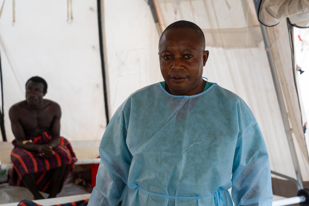 Ezekiel, an MSF nurse, walks through a temporary cholera treatment center in Lomera, South Kivu, where MSF is responding to an outbreak following a population surge.