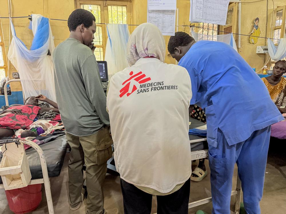 Dr Daniel Garang (left) and Dr Harizah Hamiet (middle) and nurse aid John Deng Kiir (right) attend to a young woman who lost her baby after a prolonged and obstructed labour. The woman was in labour for two days and fully dilated for five hours before she was able to reach the Aweil State Hospital for maternity care.