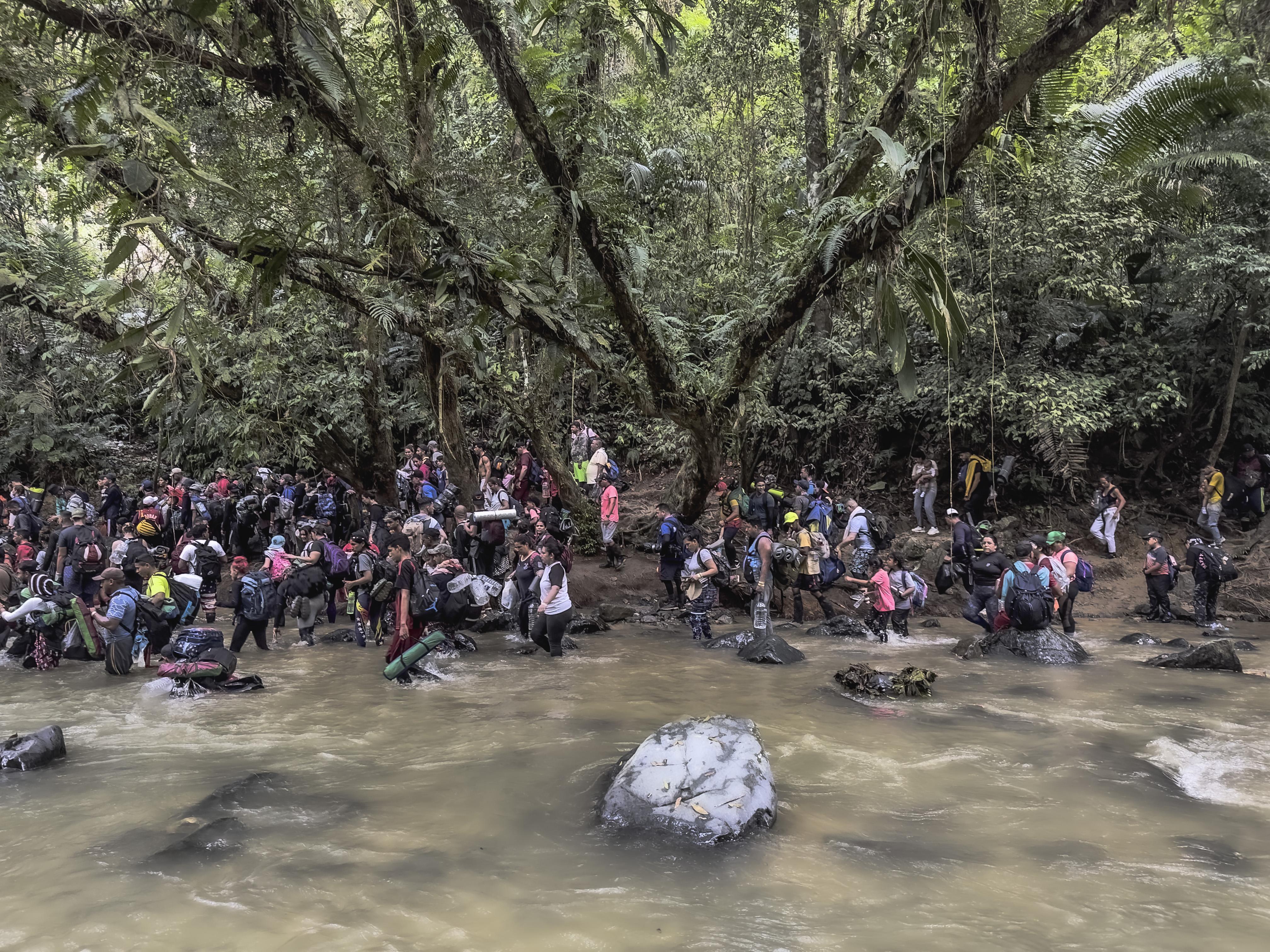Panama migrants wading through water