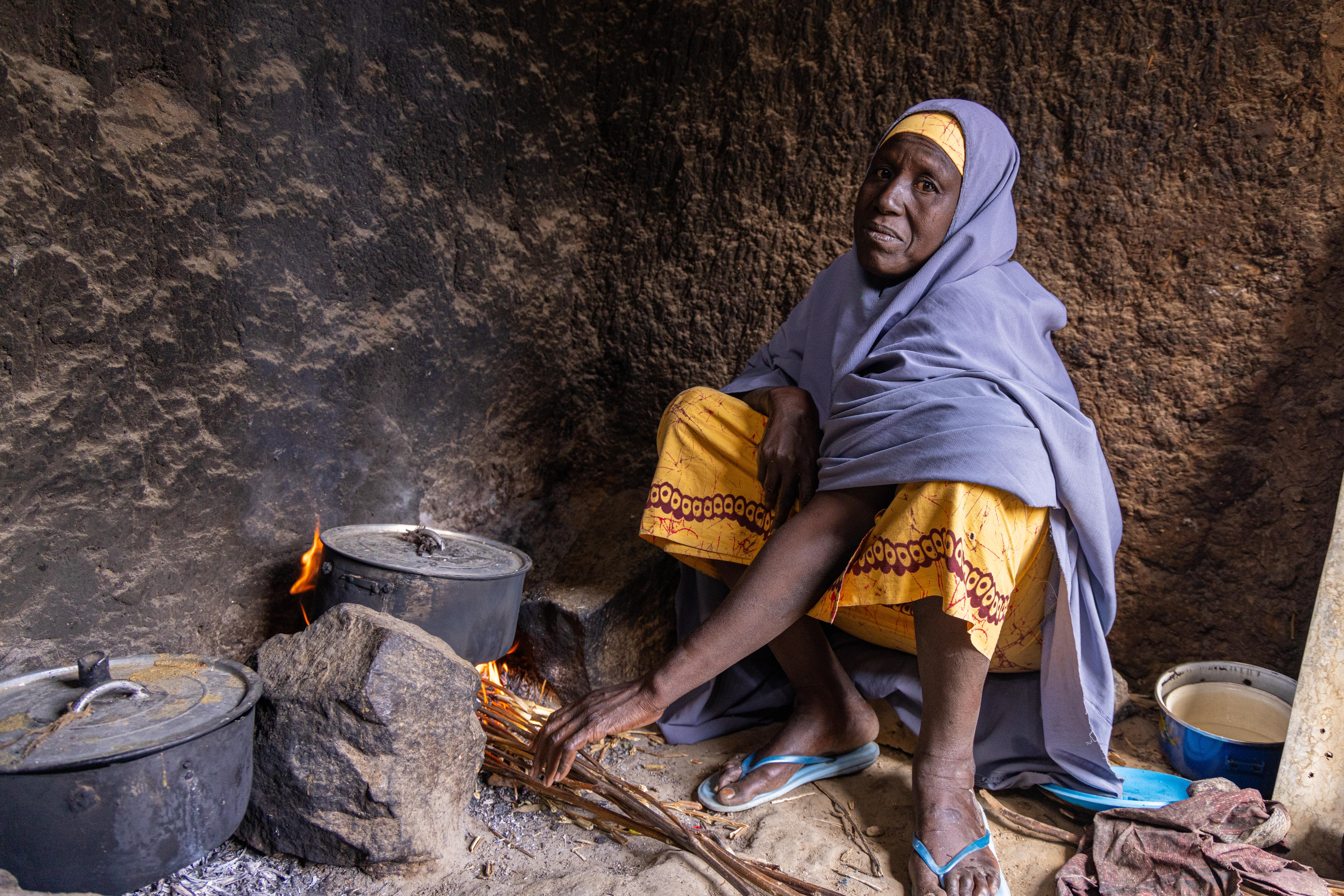 Khadijah, a traditional birth attendant in Aujara village in Jahun, Jigawa state sits in her kitchen. 
