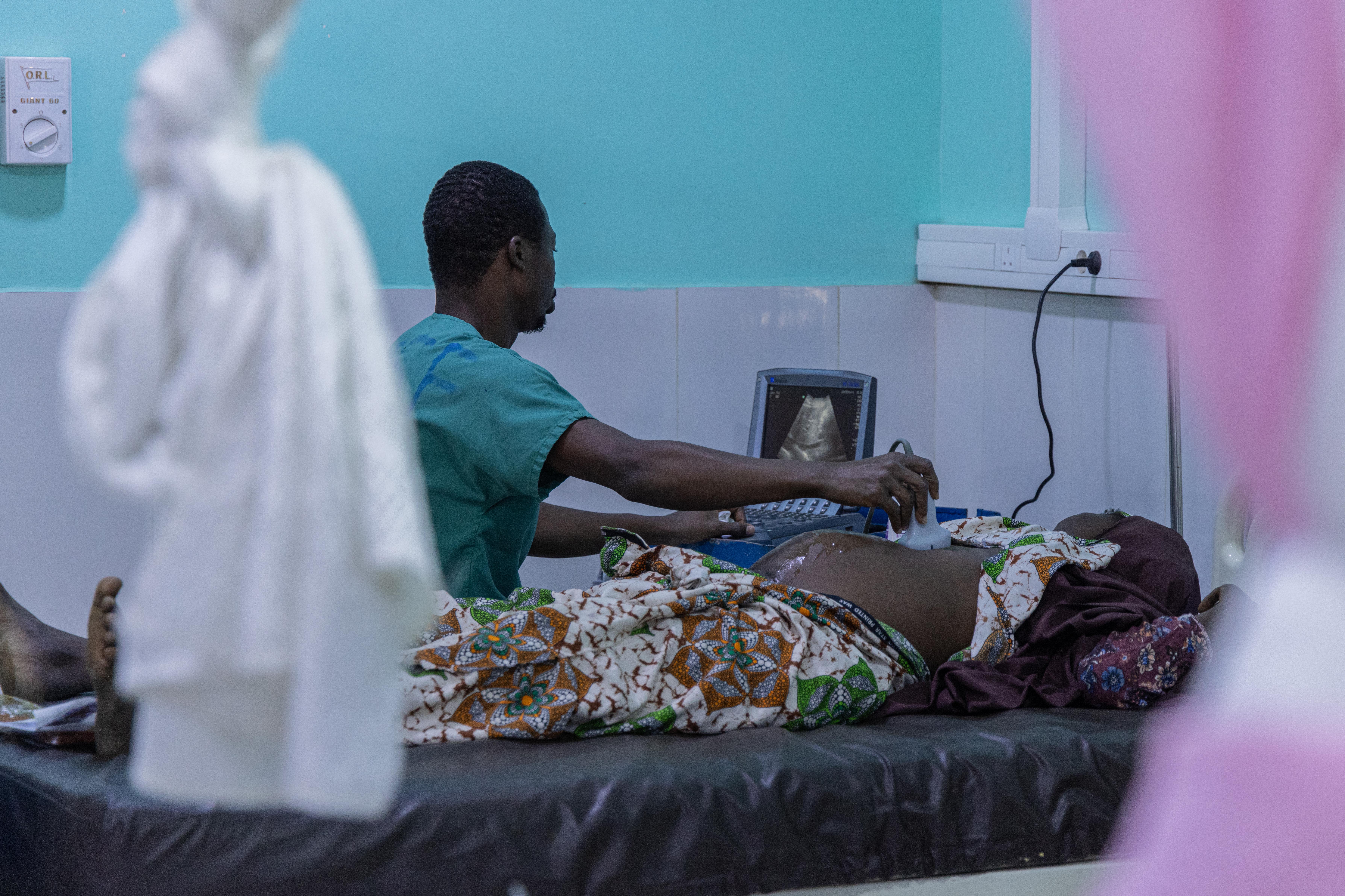 MSF doctor, Istifanus Brisca Elam conducts a scan on a pregnant woman at MSF facility in General Hospital, Jahun, Jigawa state.