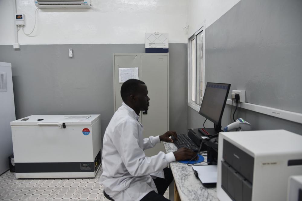MSF Laboratory supervisor Ibrahim Massaquoi inside the Makeni Regional hospital tuberculosis laboratory, Bombali district, Sierra Leone, recording results of TB tests.