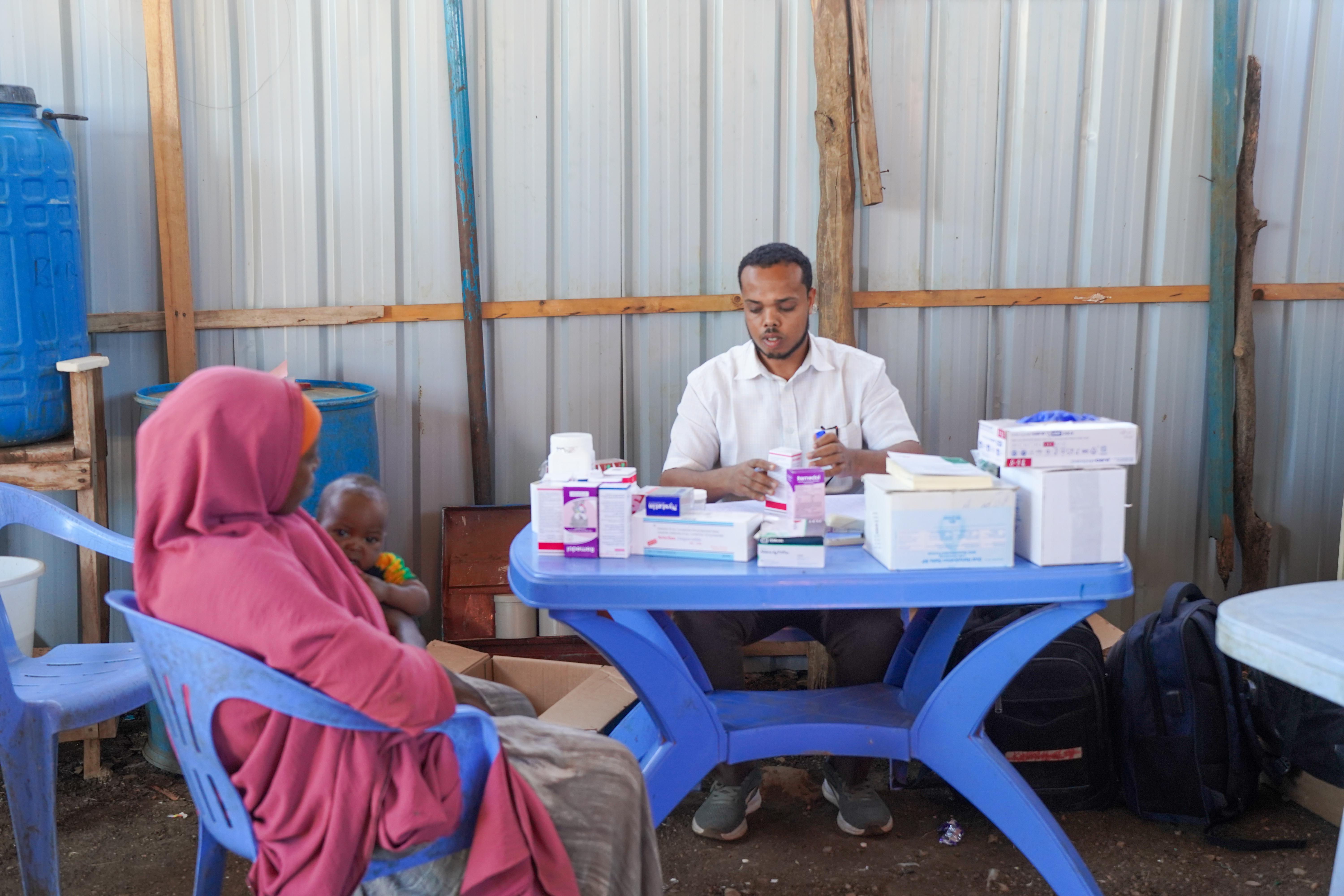 Nutrition Assistant Ramadan Mohamed Adan updates the patient register