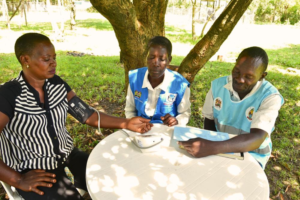  Pamela Anyango, patient advocate (left) gets a blood pressure reading