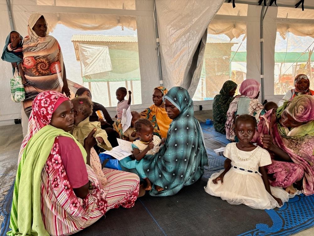 A group of mothers at the MAM clinic feed their moderately malnourished children with Plumpy’Sup provided by MSF.  MAM Clinic, Dabaniera Camp, Tawila, North Darfur.