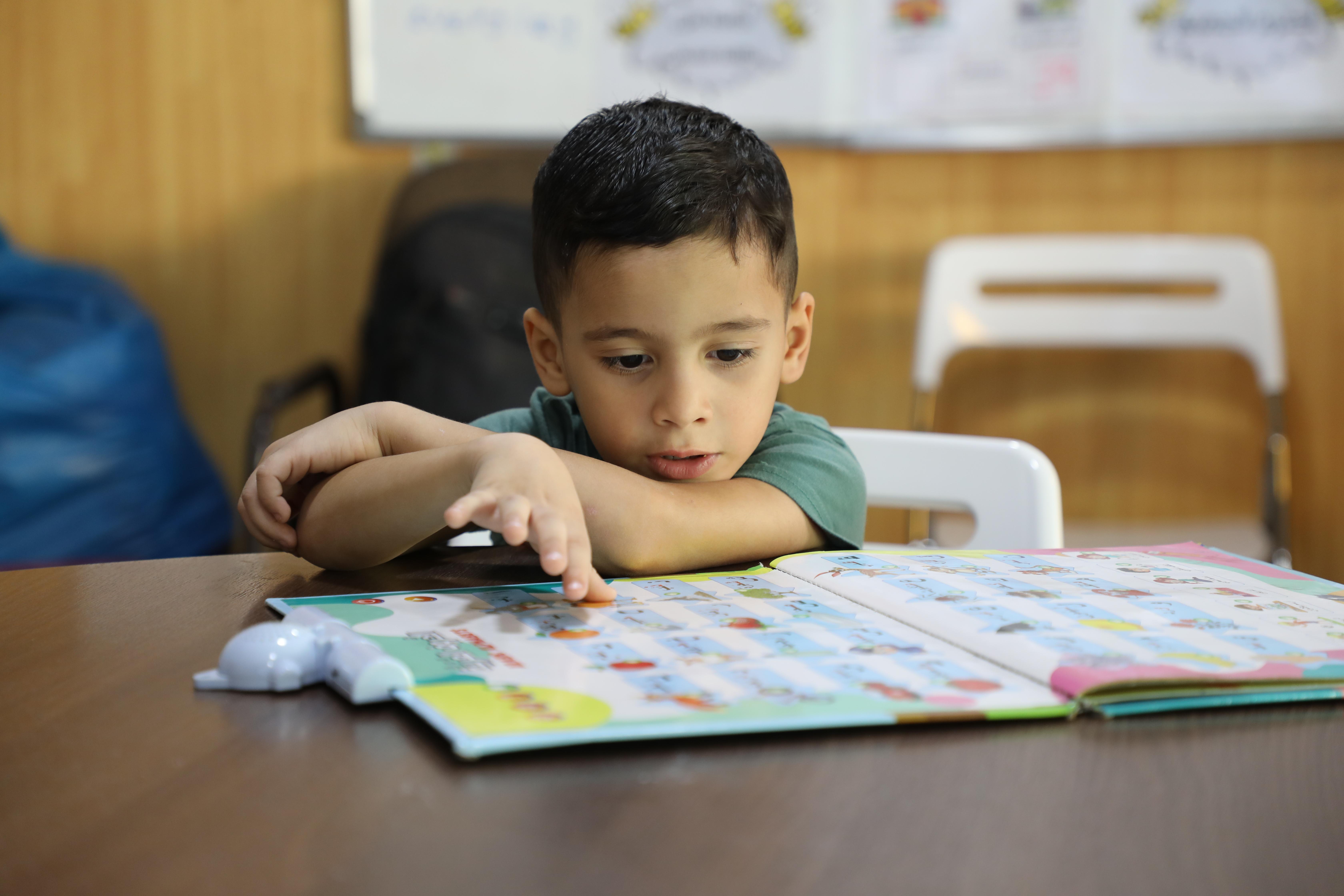 Omar in class at the reconstructive surgery hospital in Amman, Jordan. Omar was injured in an Israeli strike, after a piece of shrapnel tore through his leg.
