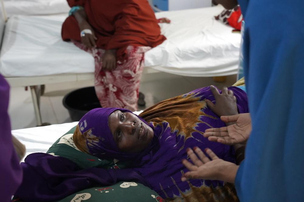 A woman receives emotional support from a midwife by explaining to her what she’s suffering from and the process of the treatment inside the maternity ward