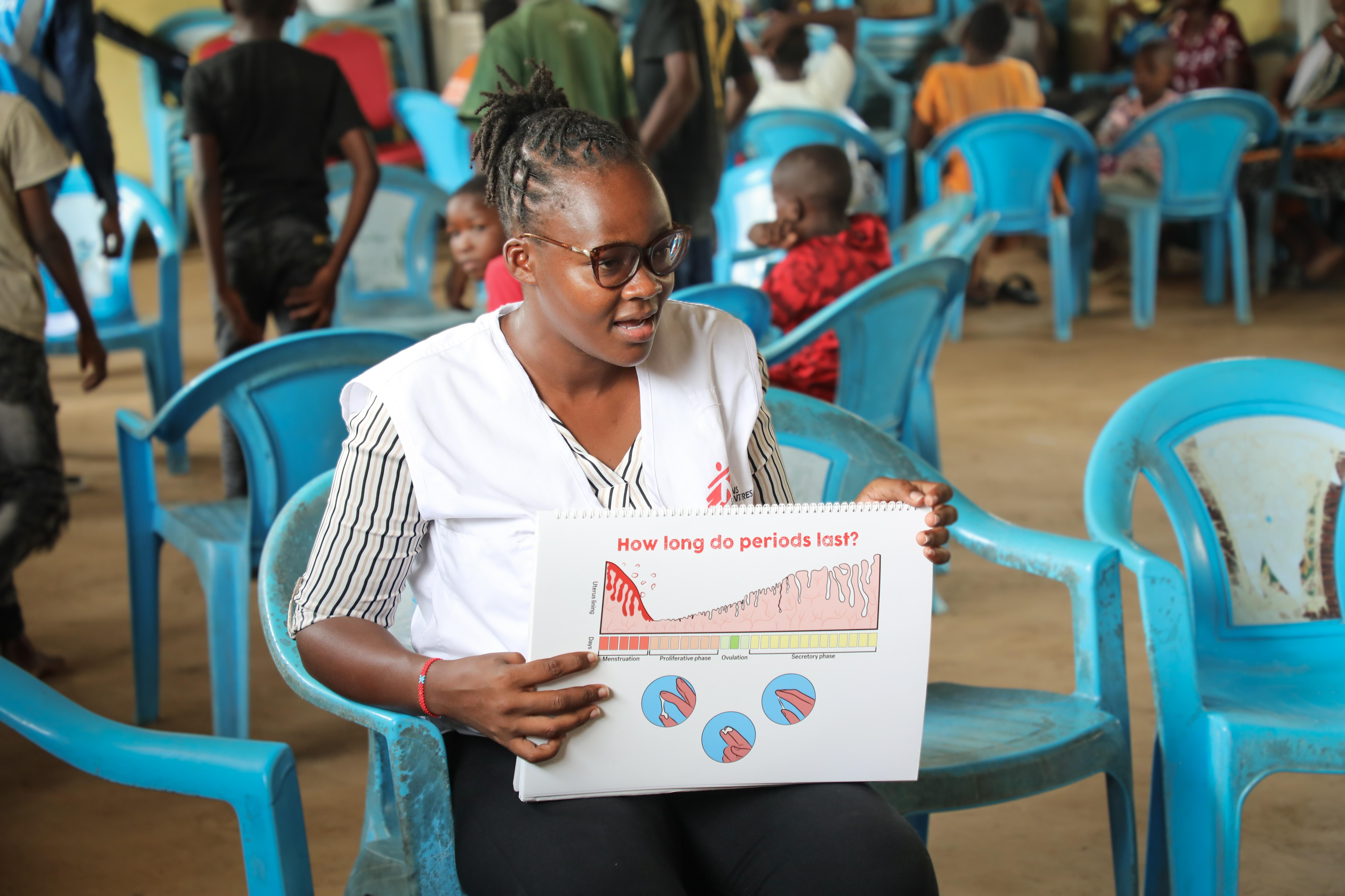 A person holding a calendar, symbolizing tracking menstrual cycles and learning about periods.