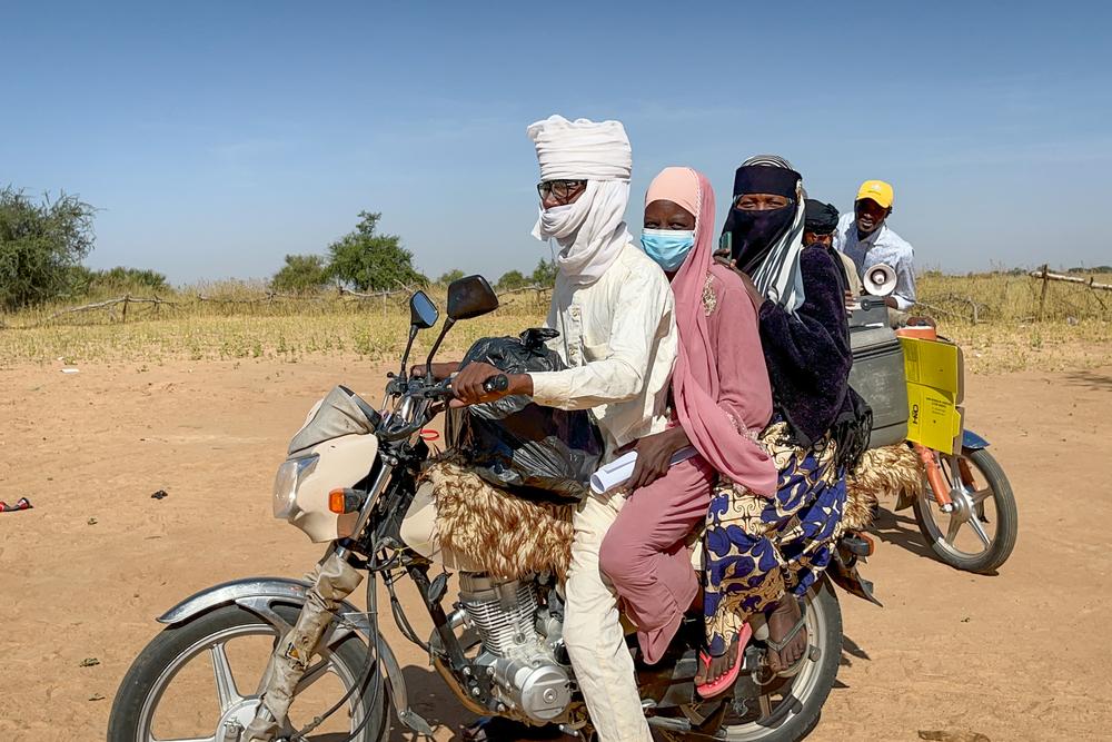 MSF staff riding motorcycles to reach remote communities in Chad for diphtheria vaccination efforts.