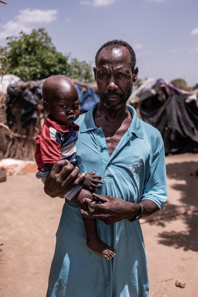 "There is no food to feed the baby. I don’t have work to provide him with food. We have become weak." Mohamed Khamis Abdelmolla and his son Mobasher in an IDP camp in Hamidya. 