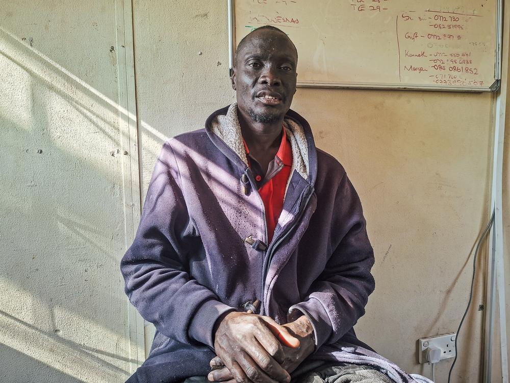 Freedom Matemavi, (46), stands outside a clinic in Beitbridge, Zimbabwe. A Zimbabwean returnee from South Africa, Thompson worked as an electrician and plumber there since 2009 before anti-migrant groups' campaign to force foreigners out of public hospitals cut off his access to antiretroviral (ARV) treatment for three months.