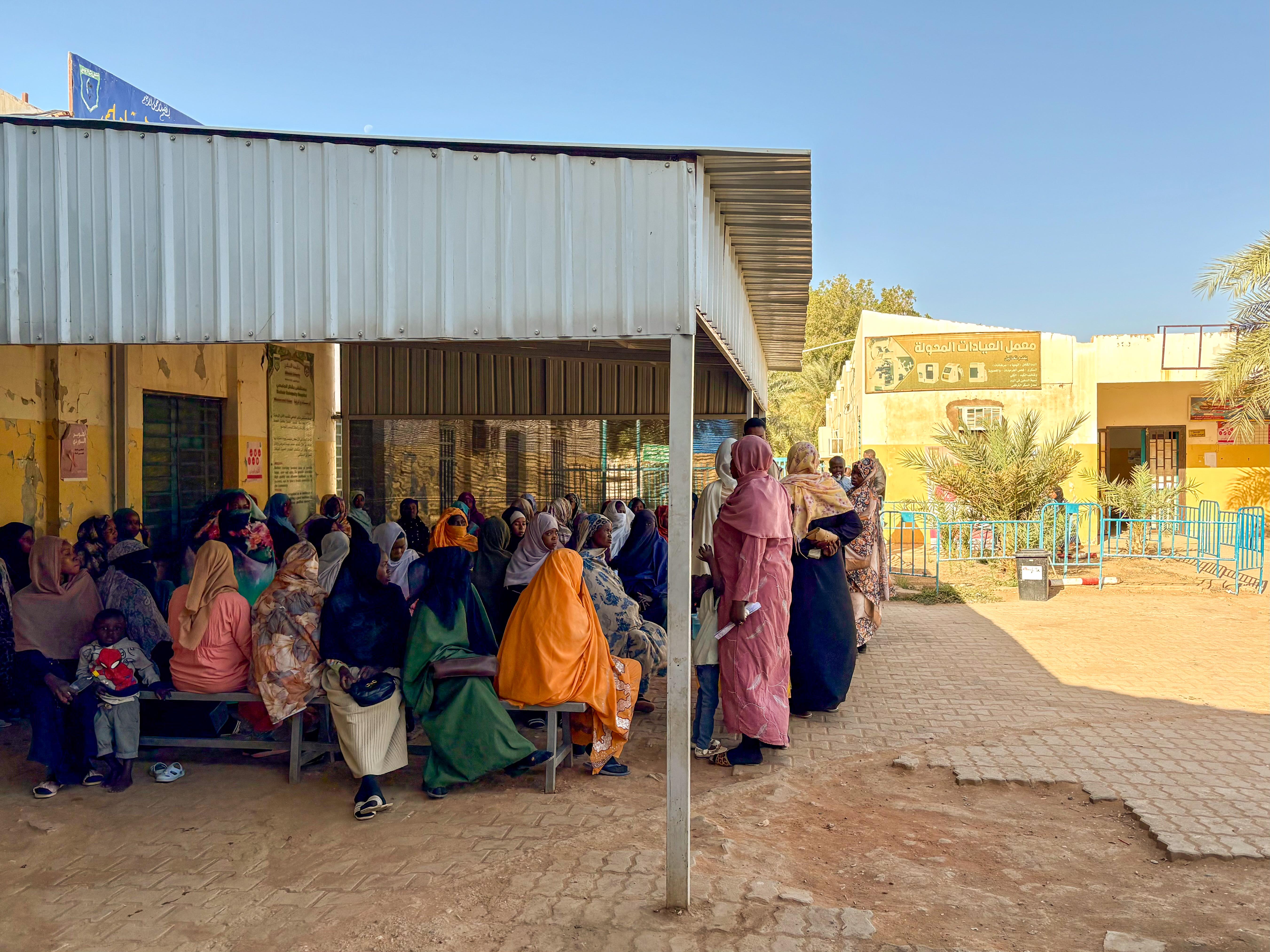 View of the crowded waiting area at the main entrance of Bashair Teaching Hospital.