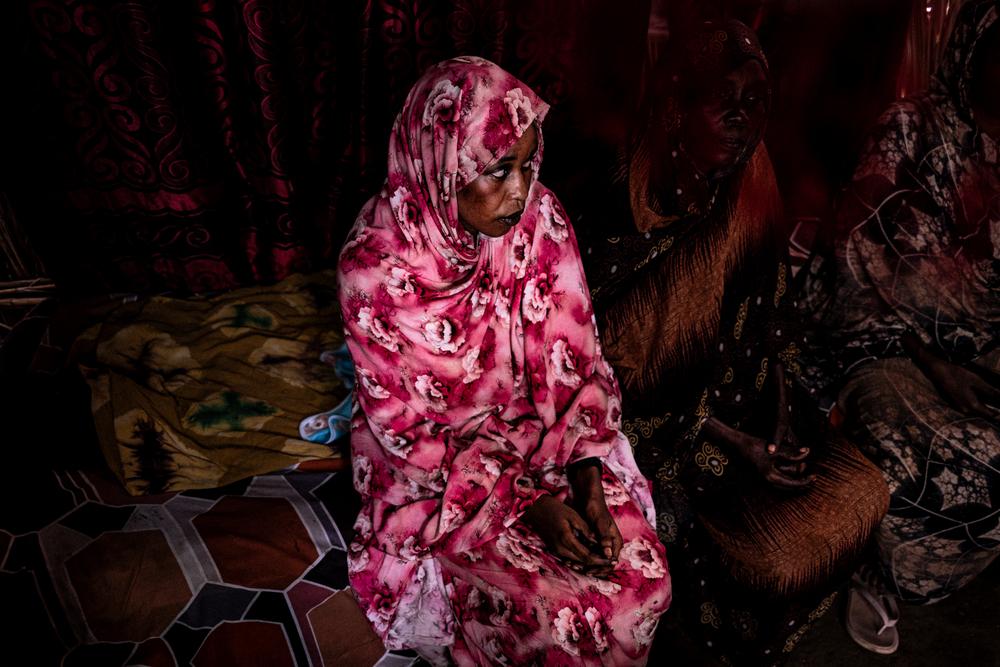 Safa Mohamed Mansour and sits in the room she shares with four other women who were also displaced by fighting in Sudan's war. Safa hopes that one day she will be able to return to university and complete her nursing degree. 25 July, Zalingei, Central Darfur